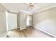 Bedroom showcasing a sliding mirror door closet, ceiling fan and hardwood floors at 4736 Walden Pond Dr, Raleigh, NC 27604