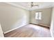 Bedroom featuring a ceiling fan, light gray walls, and new wood-look flooring at 4736 Walden Pond Dr, Raleigh, NC 27604