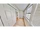 Bright sunroom featuring hardwood floors, horizontal windows with blinds, and a sliding door at 4736 Walden Pond Dr, Raleigh, NC 27604