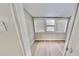 Bright sunroom featuring hardwood floors and three horizontal windows, providing plenty of natural light at 4736 Walden Pond Dr, Raleigh, NC 27604