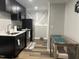 Modern kitchen with stainless steel appliances, dark wood cabinetry and a small table with chairs at 4736 Walden Pond Dr, Raleigh, NC 27604