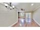 Bright living room featuring hardwood floors, ceiling fan, and stylish wall paneling at 4736 Walden Pond Dr, Raleigh, NC 27604