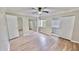 Spacious main bedroom featuring a ceiling fan, hardwood floors, sliding closet door and two doorways at 4736 Walden Pond Dr, Raleigh, NC 27604