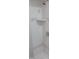 Clean white shower with a shower head and soap holder built into the tile wall at 4736 Walden Pond Dr, Raleigh, NC 27604