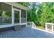 A covered back porch with gray wood and a screened section offers outdoor enjoyment at 4804 Carmen Ln, Durham, NC 27707