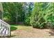 A well-maintained backyard surrounded by lush greenery and tall trees at 4804 Carmen Ln, Durham, NC 27707
