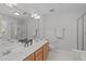 Bathroom showcasing a double vanity, a framed mirror, a separate shower, and a soaking tub at 4804 Carmen Ln, Durham, NC 27707