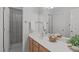 Bright bathroom featuring a white sink, a large mirror and a shower with a striped curtain at 4804 Carmen Ln, Durham, NC 27707