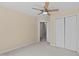 Well-lit bedroom features a ceiling fan, neutral walls, closet and open view into the ensuite bathroom at 4804 Carmen Ln, Durham, NC 27707