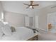 Bedroom featuring neutral walls, carpet, ceiling fan, and ensuite bathroom, offering a peaceful retreat at 4804 Carmen Ln, Durham, NC 27707
