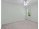 Bright bedroom features a ceiling fan, a window and carpeted floors to create a welcoming retreat at 4804 Carmen Ln, Durham, NC 27707