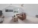 Cozy bedroom features a window, and a leather sofa with a decorative chest and a ceiling fan at 4804 Carmen Ln, Durham, NC 27707