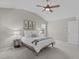 Well-lit bedroom with neutral walls, carpet, ceiling fan, and large windows, creating a bright and inviting space at 4804 Carmen Ln, Durham, NC 27707