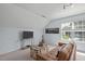 Angled ceiling bedroom features a window and leather sofa with a decorative chest and a ceiling fan at 4804 Carmen Ln, Durham, NC 27707