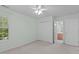 Bedroom features a ceiling fan, a window and a walk-in closet, creating a warm retreat at 4804 Carmen Ln, Durham, NC 27707