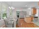 Open dining area with table, chandelier, and view into living room and kitchen at 4804 Carmen Ln, Durham, NC 27707