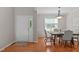 Dining room with wood floors, dining table with chairs, and front door at 4804 Carmen Ln, Durham, NC 27707