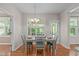 Bright dining room with wood floors, a window, and a table set for four at 4804 Carmen Ln, Durham, NC 27707