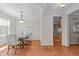 Dining room showcases hardwood floors, bright lighting, and view into kitchen at 4804 Carmen Ln, Durham, NC 27707