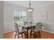 Dining room features hardwood floors, a window, and a chandelier at 4804 Carmen Ln, Durham, NC 27707