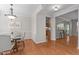 Open-concept dining room with hardwood floors, modern lighting, and connection to kitchen at 4804 Carmen Ln, Durham, NC 27707