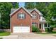 Inviting two-story brick home with a two-car garage and well-maintained landscaping at 4804 Carmen Ln, Durham, NC 27707