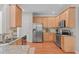 Well-lit kitchen with stone countertops, stainless appliances, and ample cabinet space at 4804 Carmen Ln, Durham, NC 27707