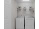 Practical laundry room with side by side washer and dryer, and a shelf with decorative boxes at 4804 Carmen Ln, Durham, NC 27707