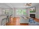 Bright living room features a fireplace, hardwood floors, and views to the backyard at 4804 Carmen Ln, Durham, NC 27707