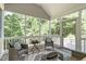 Inviting screened porch featuring wicker furniture and scenic backyard views at 4804 Carmen Ln, Durham, NC 27707