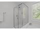 Modern bathroom shower with a glass enclosure, showcasing sleek fixtures and ample natural light at 4804 Carmen Ln, Durham, NC 27707