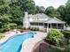 Aerial view of backyard with inground pool, stone firepit and surrounding landscaping at 5005 Lenoraway Dr, Raleigh, NC 27613