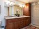 Elegant bathroom features a double vanity, granite countertops, and a large, well-lit mirror at 5005 Lenoraway Dr, Raleigh, NC 27613
