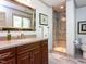 Bathroom with vanity, framed mirror, tile floors and glass enclosed shower, plus natural light at 5005 Lenoraway Dr, Raleigh, NC 27613