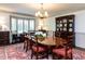 Elegant dining room with a large table, chandelier, and bay window, perfect for entertaining guests at 5005 Lenoraway Dr, Raleigh, NC 27613