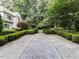 Long driveway framed by manicured landscaping, leading to a distinguished home at 5005 Lenoraway Dr, Raleigh, NC 27613