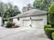 Exterior of a white brick home featuring a two-car garage at 5005 Lenoraway Dr, Raleigh, NC 27613