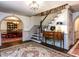Inviting foyer featuring hardwood floors, staircase, and elegant archway to dining area at 5005 Lenoraway Dr, Raleigh, NC 27613