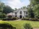 Stately brick residence featuring lush front yard and mature trees at 5005 Lenoraway Dr, Raleigh, NC 27613