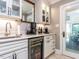 Stylish kitchen features a wine refrigerator, built in appliances and white cabinets at 5005 Lenoraway Dr, Raleigh, NC 27613