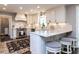 Well-lit kitchen with white cabinets, stainless steel appliances, and a charming breakfast bar at 5005 Lenoraway Dr, Raleigh, NC 27613