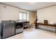 Well-lit laundry room with front loading washer and dryer, utility sink and folding table at 5005 Lenoraway Dr, Raleigh, NC 27613