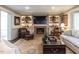 Cozy living room with fireplace, TV, built in shelves and bay window at 5005 Lenoraway Dr, Raleigh, NC 27613