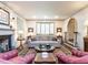 Bright living room features fireplace, bay window, and comfortable seating arrangement at 5005 Lenoraway Dr, Raleigh, NC 27613