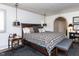 Relaxing main bedroom features a plaid comforter, bedside tables, and modern pendant lights at 5005 Lenoraway Dr, Raleigh, NC 27613