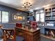 Sophisticated home office with custom bookshelves, paneled walls, and a large desk at 5005 Lenoraway Dr, Raleigh, NC 27613
