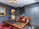 Another angle of the sophisticated home office with custom bookshelves and a large desk at 5005 Lenoraway Dr, Raleigh, NC 27613
