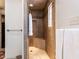 Neutral colored tiled stand up shower with decorative tile border, built in seat, and shower head at 5005 Lenoraway Dr, Raleigh, NC 27613