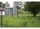 Fenced backyard featuring a storage shed and grassy area, perfect for outdoor activities and additional storage at 503 N Franklin Dr, Sanford, NC 27330