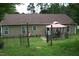 Fenced backyard with a patio area and gazebo, offering a relaxing outdoor living space at 503 N Franklin Dr, Sanford, NC 27330